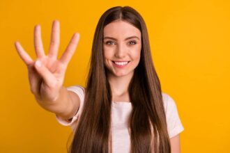 Young Caucasian woman holding up four fingers