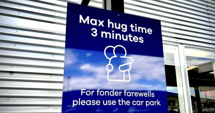 A sign informing time limits for visitors to the passenger drop-off area outside Dunedin Airport in Momona, New Zealand, Oct. 8, 2024. Travelers wanting to embrace for longer can relocate to the parking lot. (Sarah Soper/Dunedin Airport via AP)