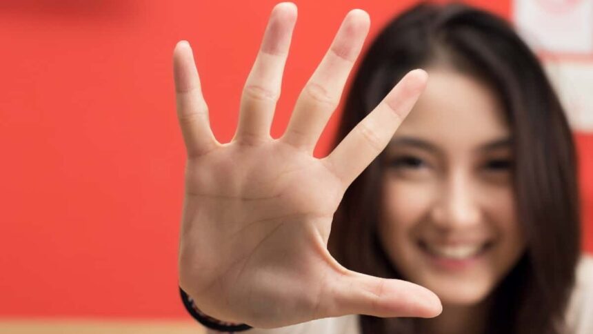 Young female hand showing five fingers.