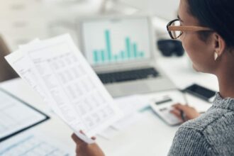 Businesswoman calculating finances in an office