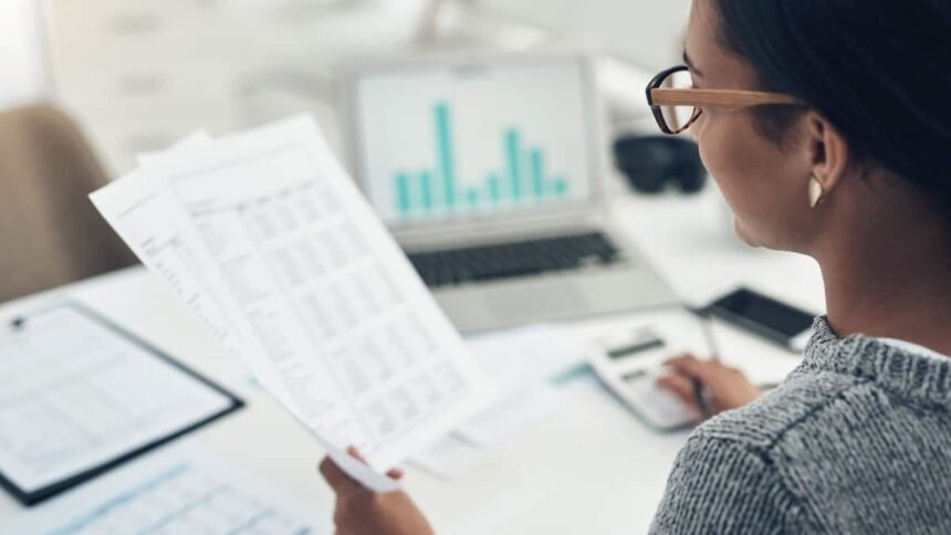 Businesswoman calculating finances in an office