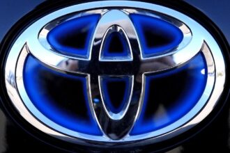 Scandal-hit car maker Toyota sees profits take a tumble