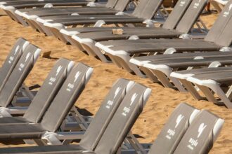 ‘Not for sale’: Anti-tourism protestors destroy hundreds of sunbeds in Tenerife